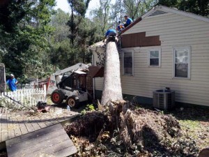 A man is working on the side of a house