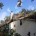 A man is working on the roof of a house.