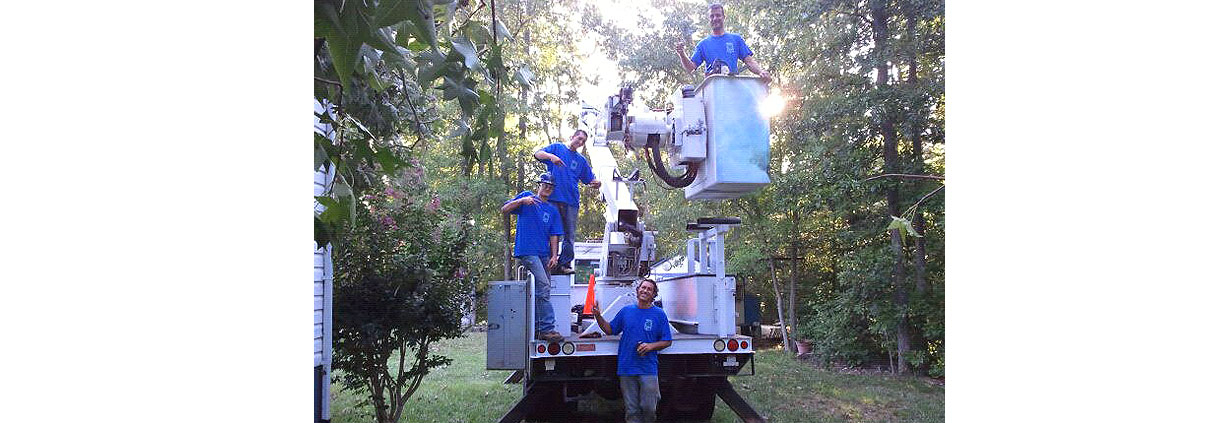 A group of people standing on top of a truck.