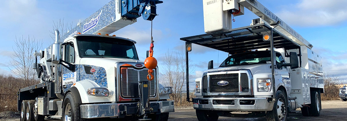 A crane is attached to the back of a truck.